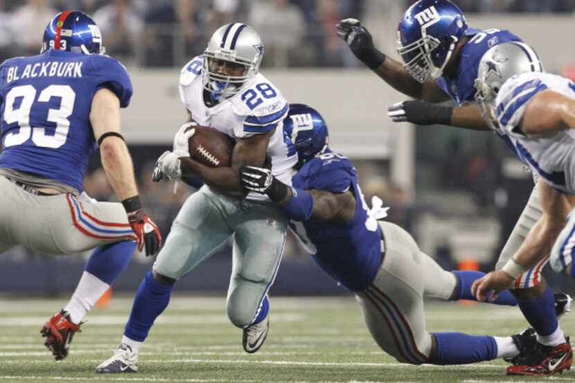 Dallas RB Felix Jones (28) runs through the NY line in the second quarter in a NFL game...