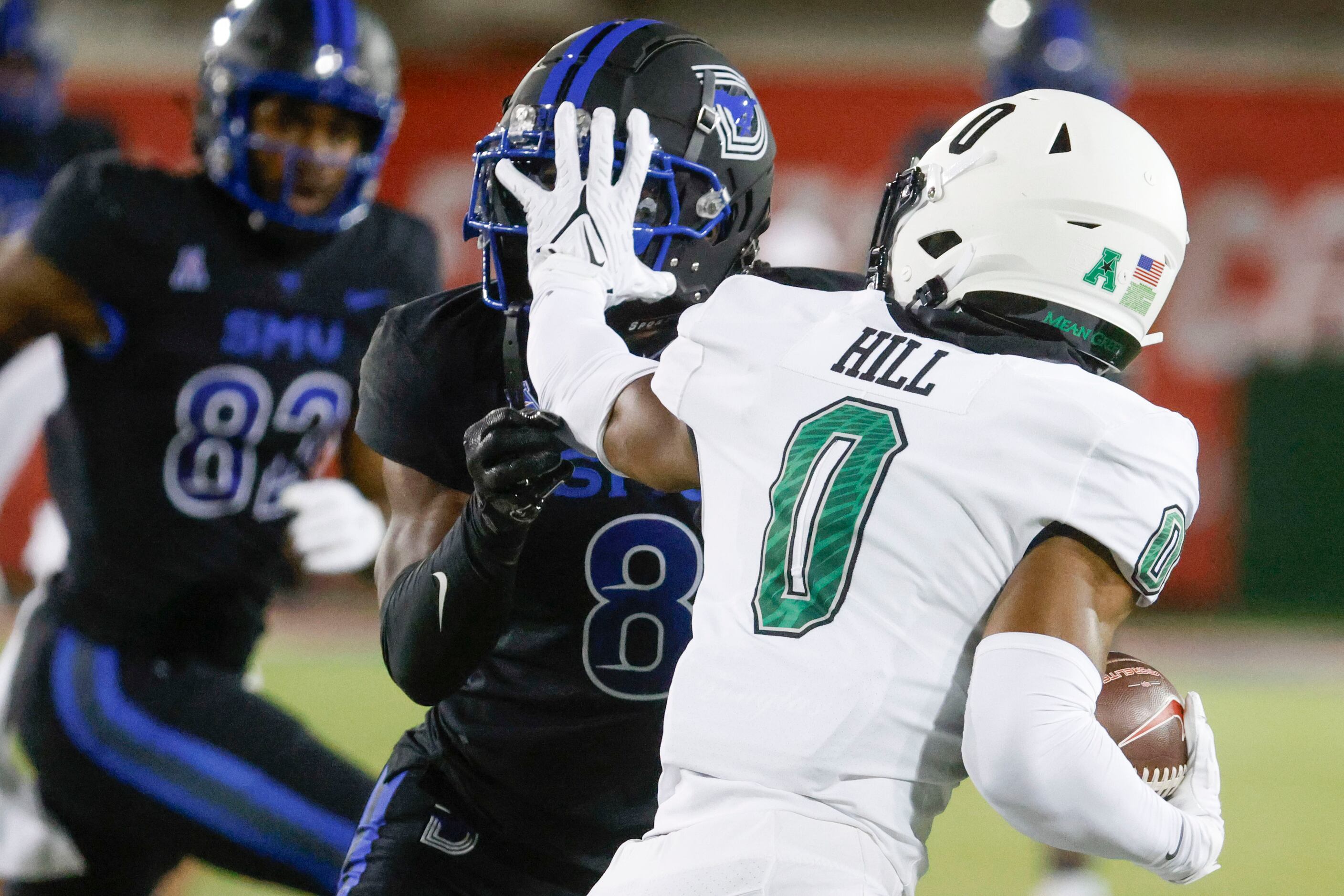 Southern Methodist Mustangs linebacker JaQwondis Burns gets blocked by North Texas Mean...