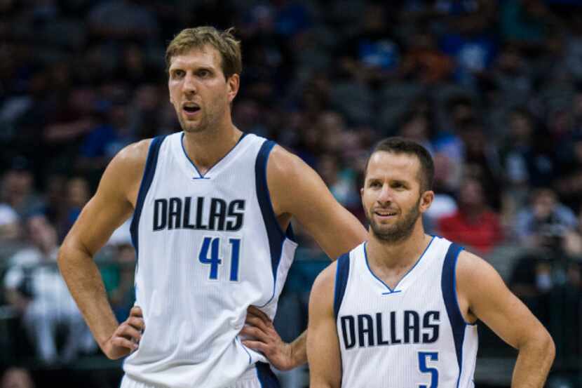 Dallas Mavericks forward Dirk Nowitzki (41) and Dallas Mavericks guard J.J. Barea (5) watch...