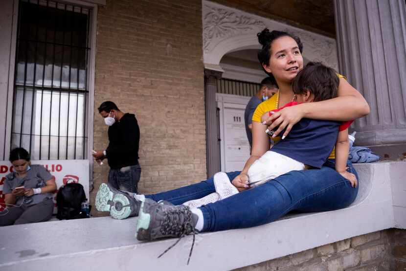 Caro Sánchez, 21, from Colombia holds her 2-year-old son Geronimo as they wait for a family...