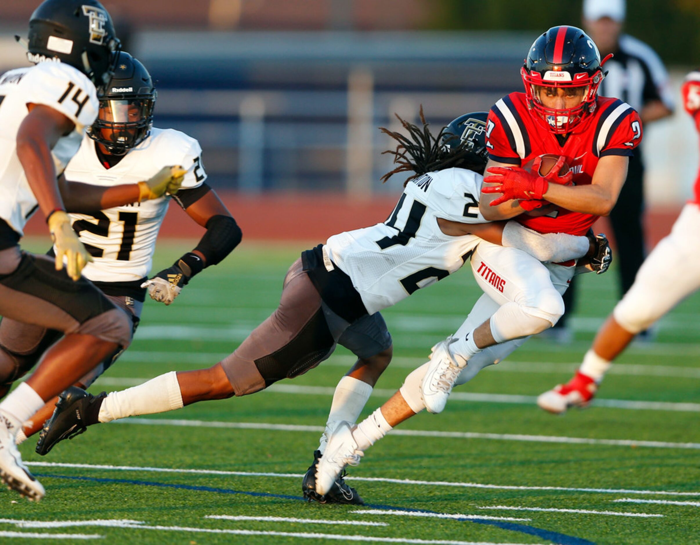 Centennial's Trysten Meadors (2) is tackled by The Colony's Shafiq Taylor (24) during the...