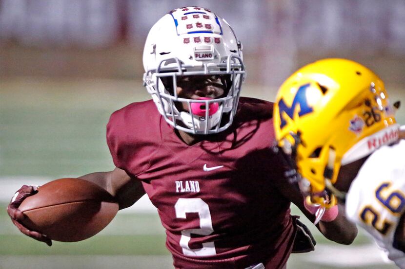 Plano Senior High School running back Kyron Cumby (2) cuts back in front of McKinney High...