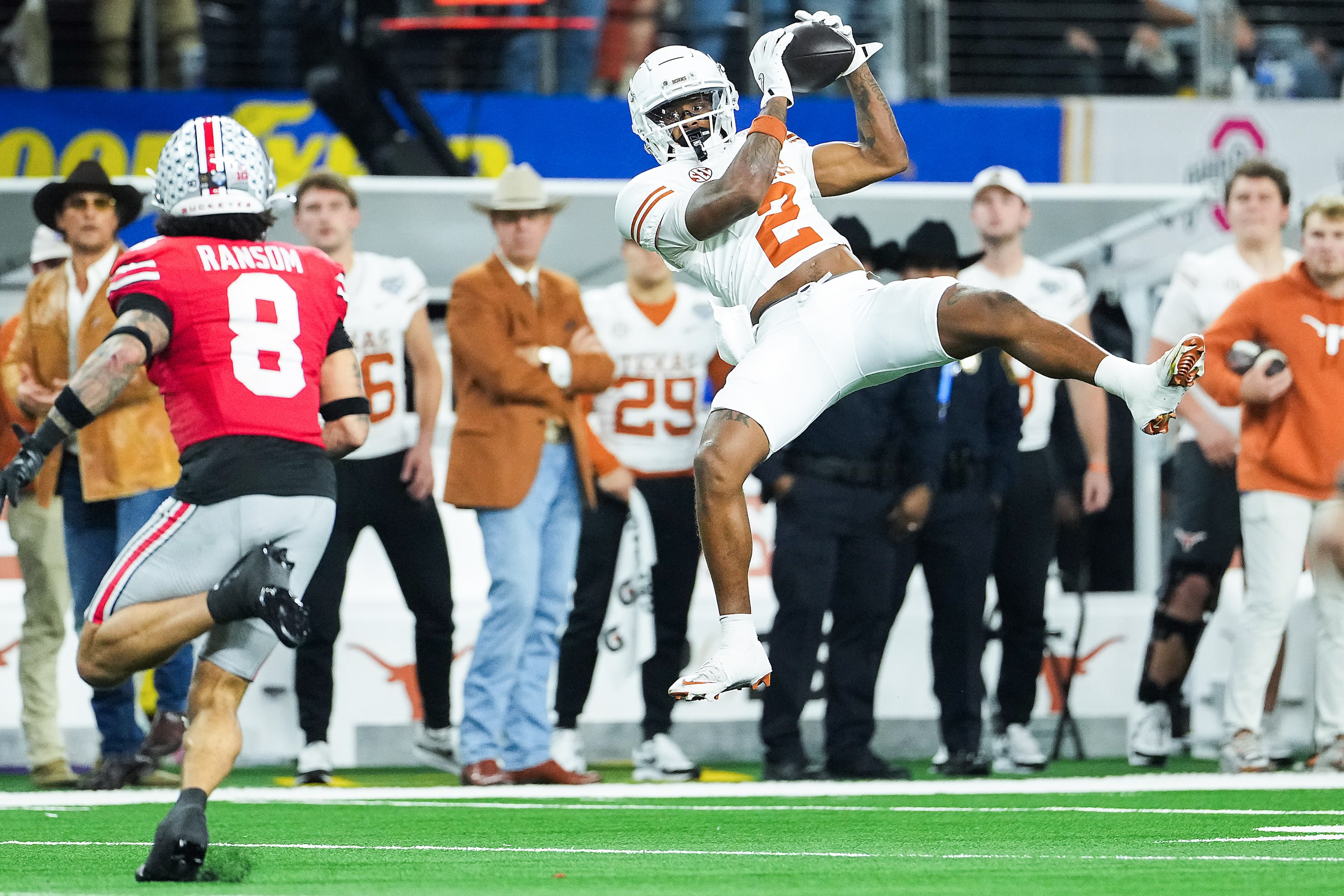 Texas wide receiver Matthew Golden (2) hauls in a 27-yard pass as Ohio State safety Lathan...