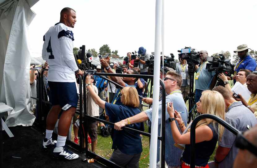 Dallas Cowboys quarterback Dak Prescott (4) answers questions from the media after a morning...