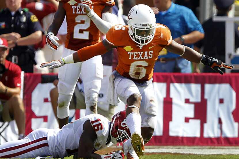 Texas Longhorns cornerback Quandre Diggs (6) shows he stopped Oklahoma Sooners wide receiver...