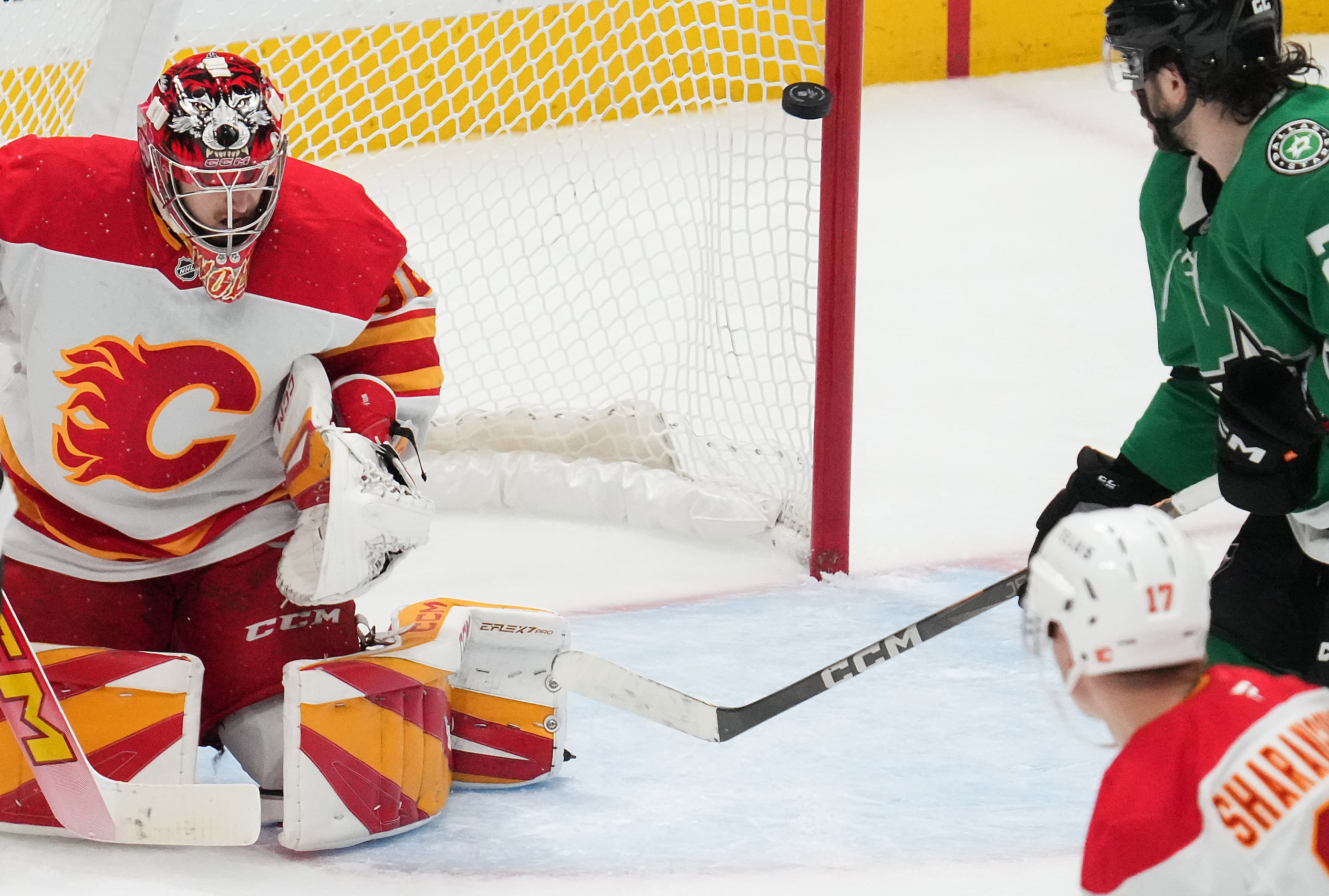 A shot by Dallas Stars defenseman Thomas Harley gets past Calgary Flames goaltender Dustin...