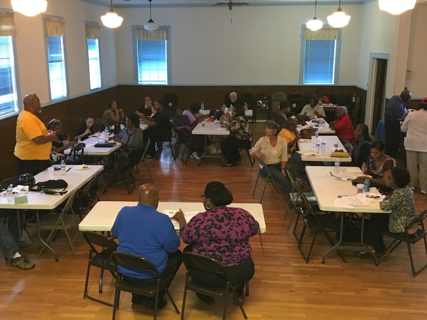 Members of the Turner Field Community Benefits Coalition listen during a meeting in...