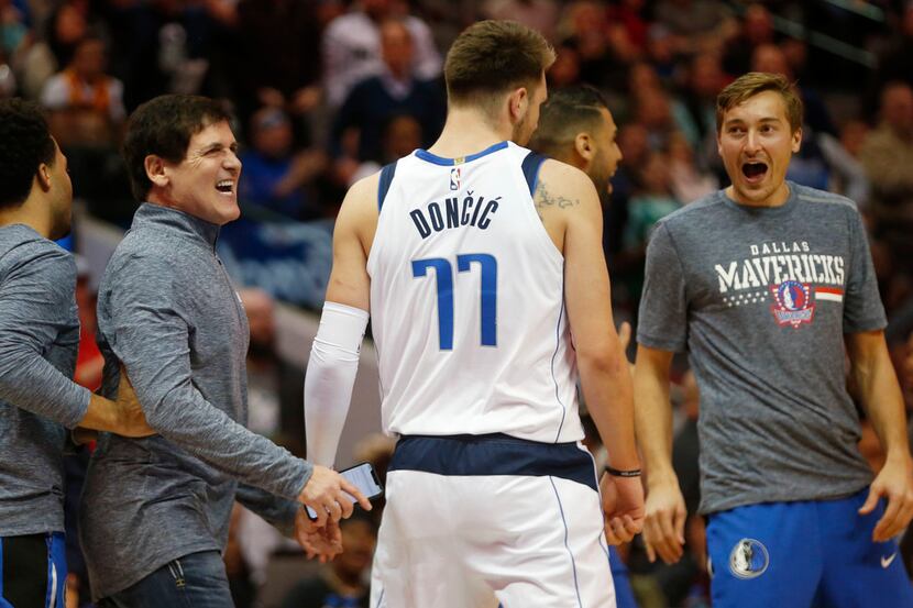 Dallas Mavericks owner Mark Cuban celebrates after Dallas Mavericks forward Luka Doncic (77)...