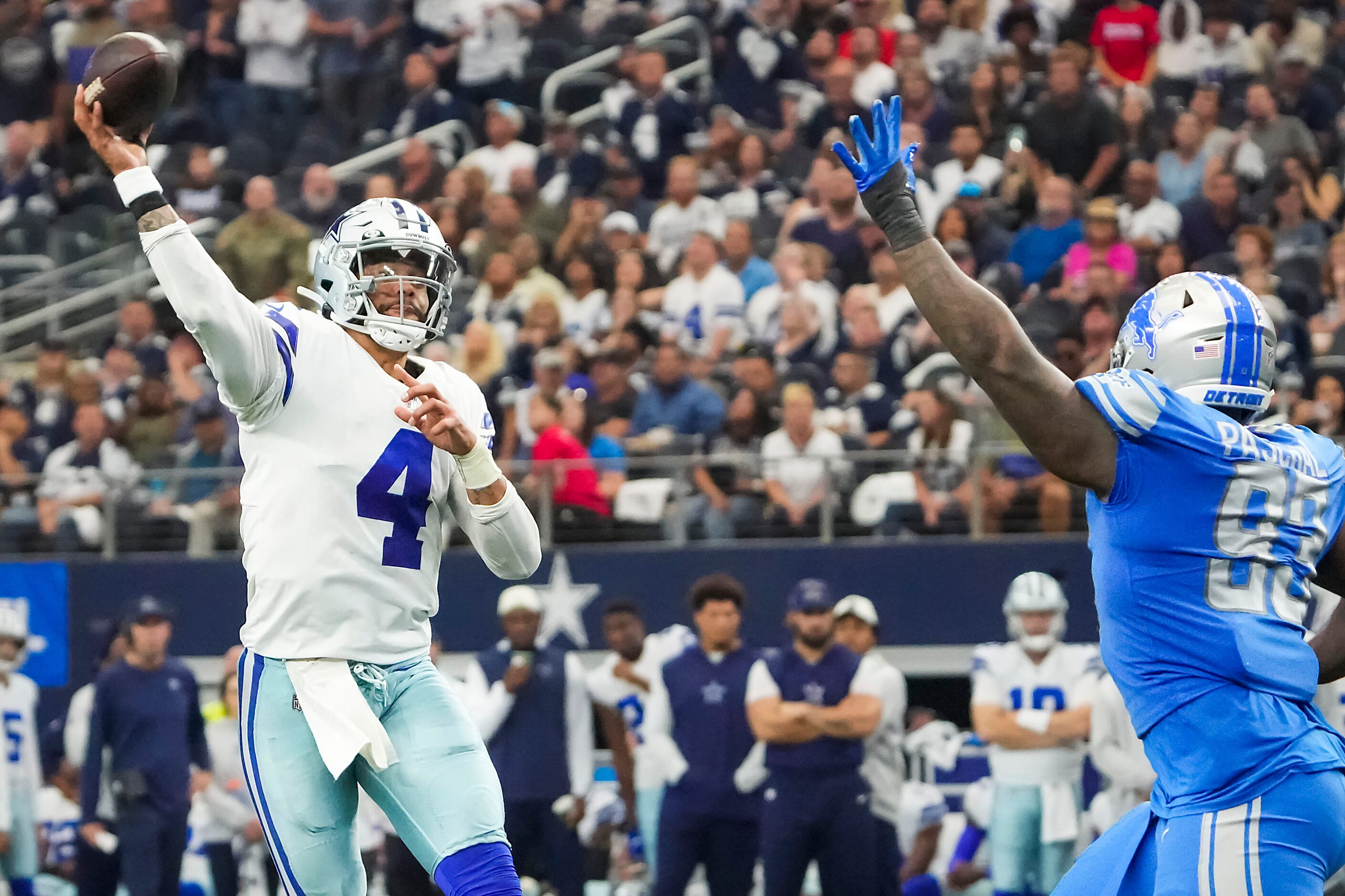 Dallas Cowboys quarterback Dak Prescott (4) throws a pass over Detroit Lions defensive end...