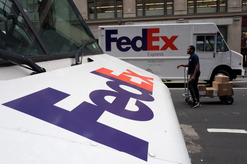 FILE - This Aug. 22, 2017 file photo shows FedEx trucks parked in New York.  FedEx plans to...