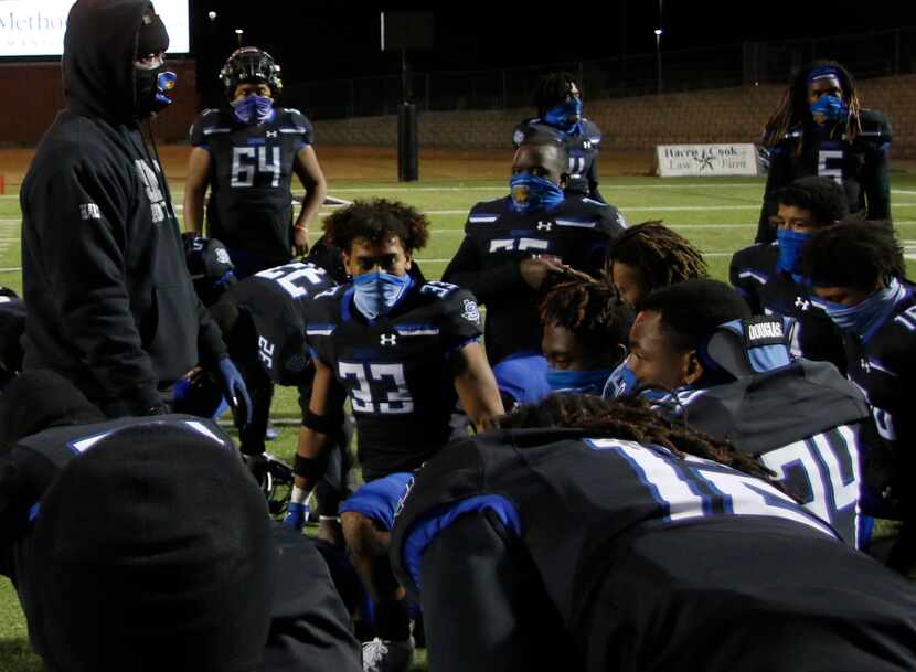 Mansfield Summit head coach Channon Hall speaks with his team following their 38-24 victory...