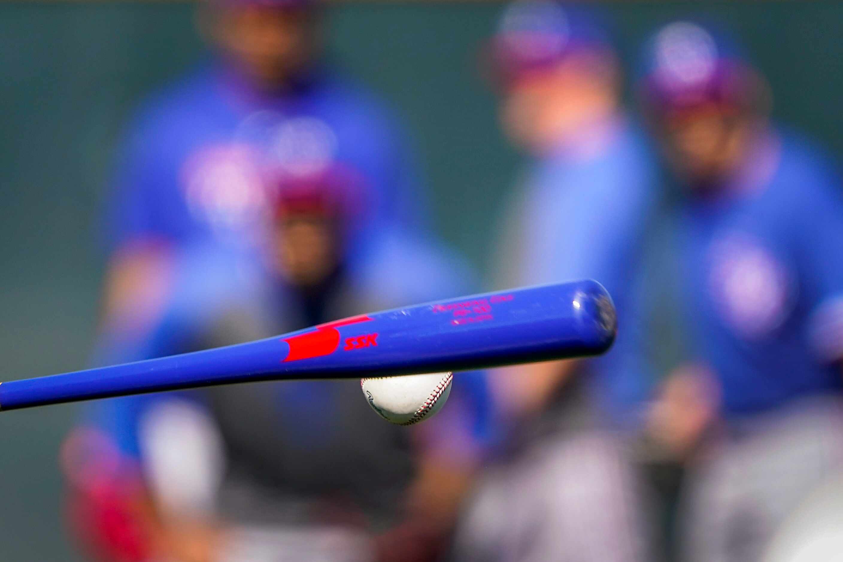 Texas Rangers pitchers take fielding practice during a spring training workout at the team's...