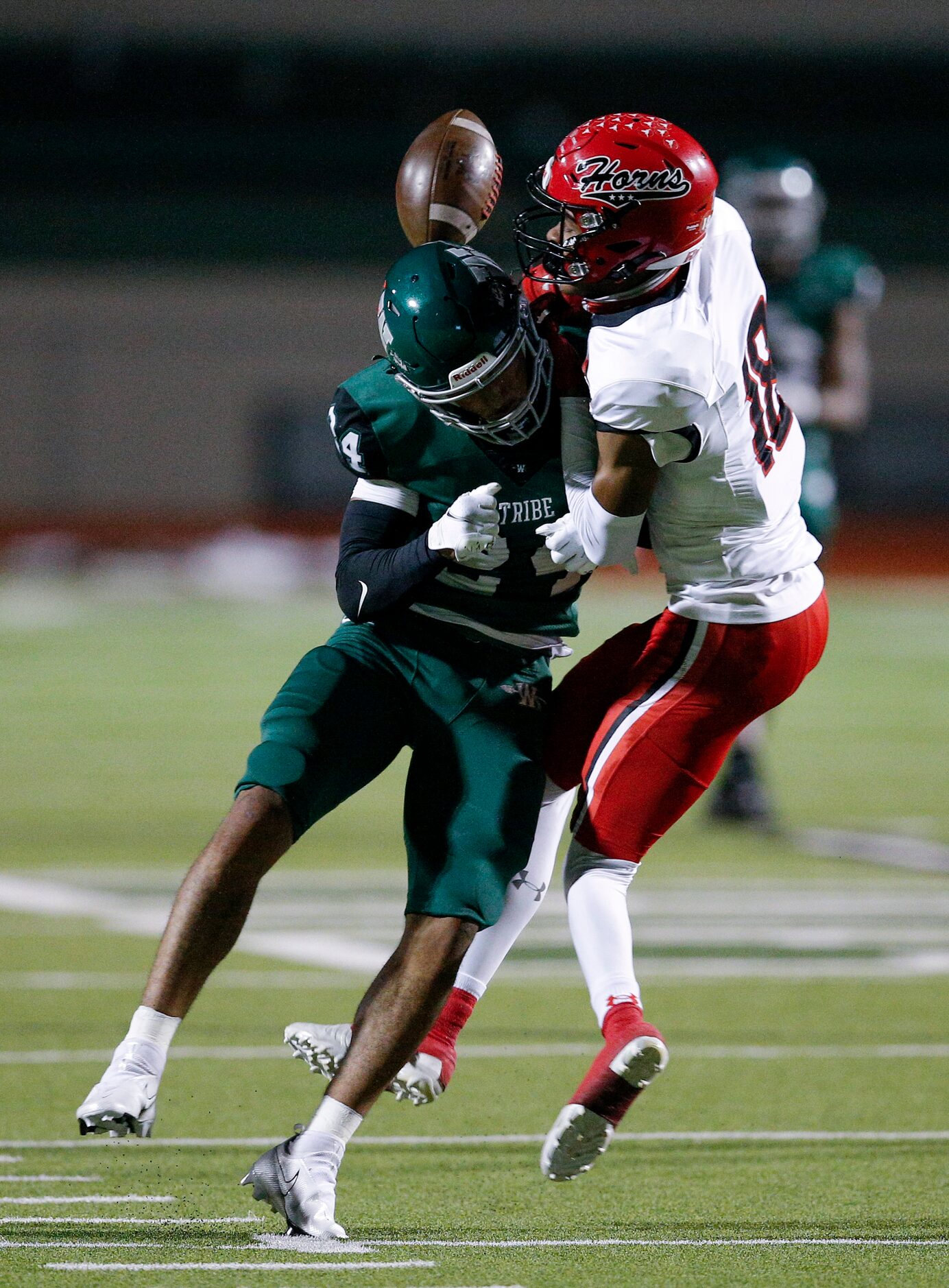 Cedar Hill senior wide receiver Jayden Moore (18) fumbles the ball after being hit by...