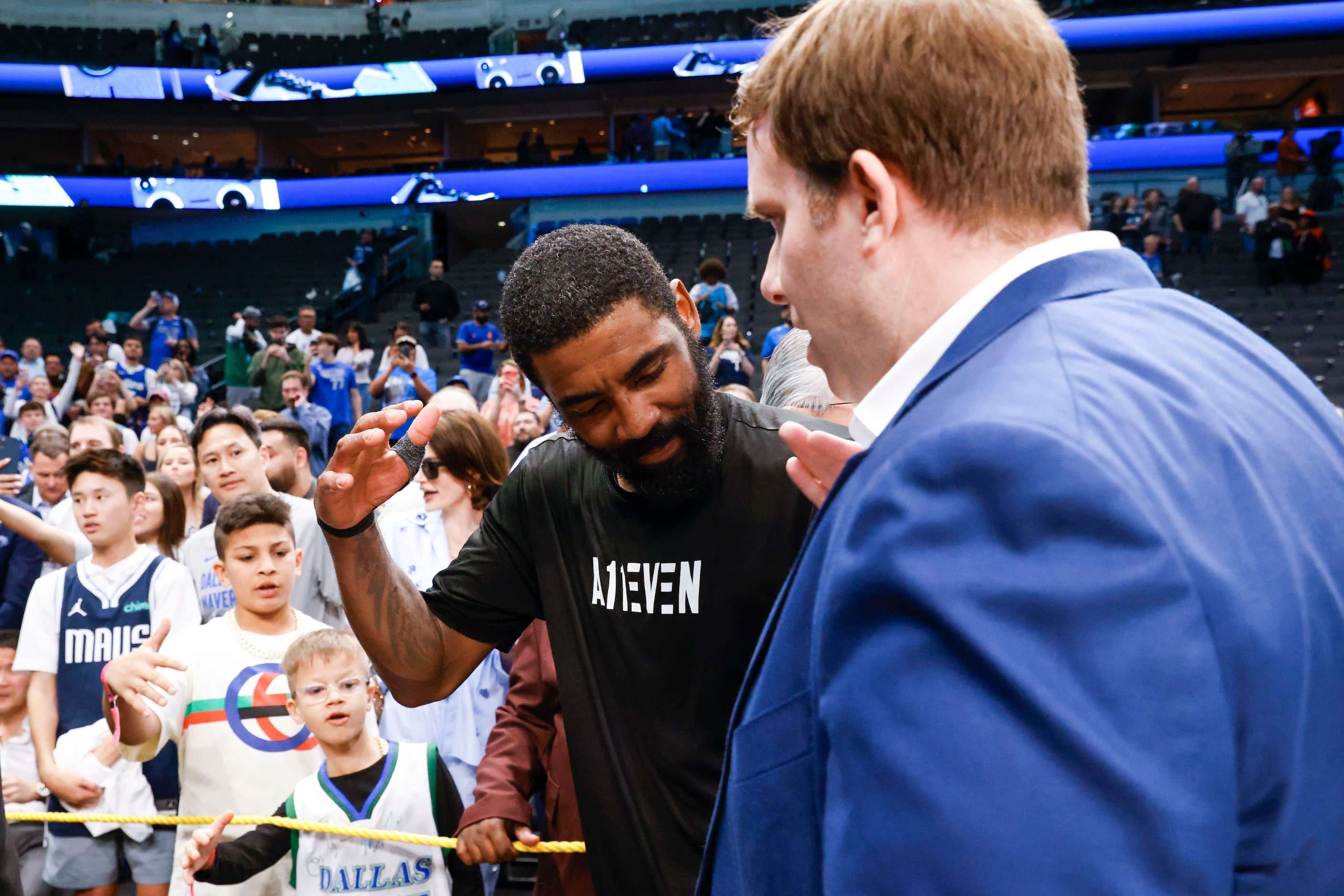 Dallas Mavericks guard Kyrie Irving (left) shakes hand with Dallas Mavericks Governor...