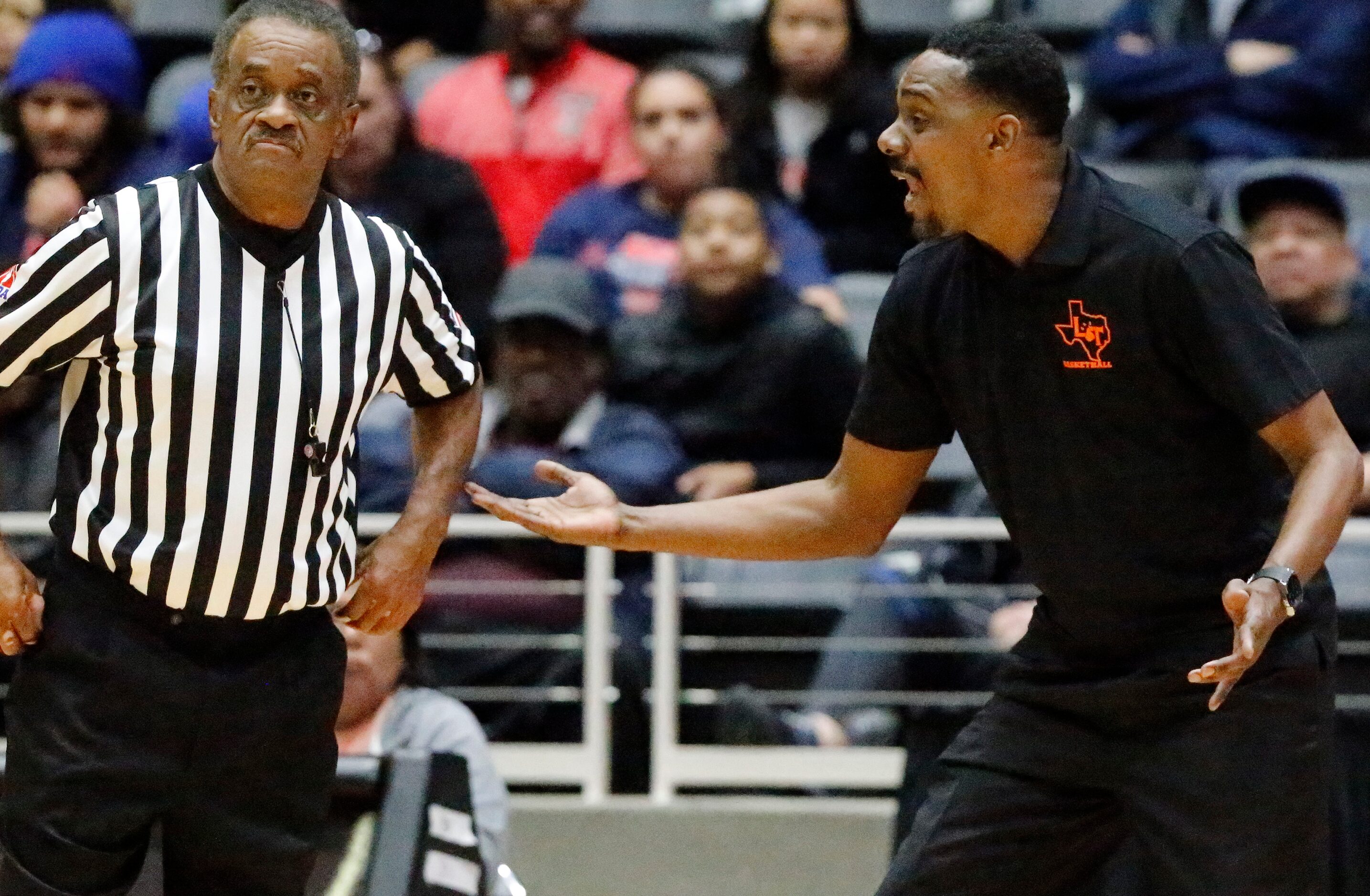 Lancaster High School head coach Ferrin Douglas tries to argue a call during the first half...