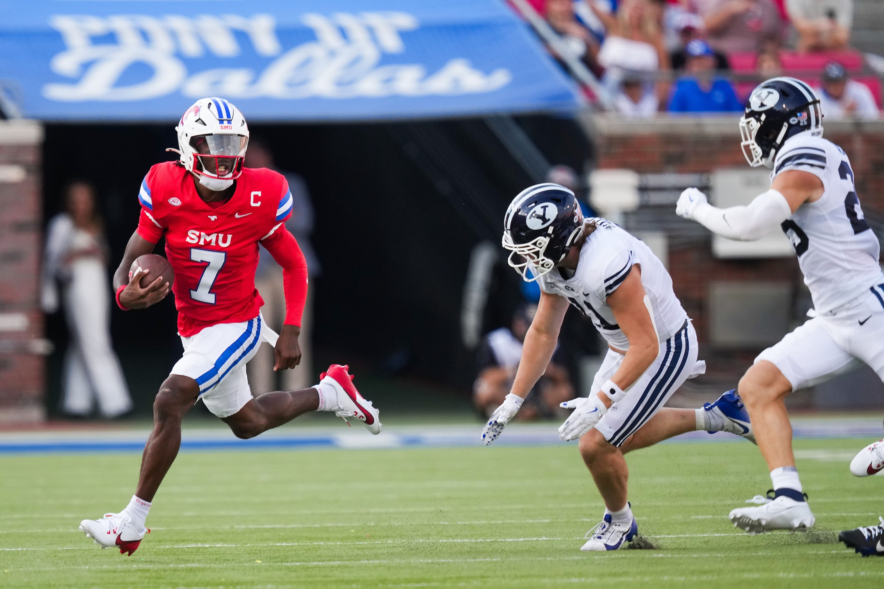 SMU quarterback Kevin Jennings (7) runs the ball during the first half of an NCAA football...