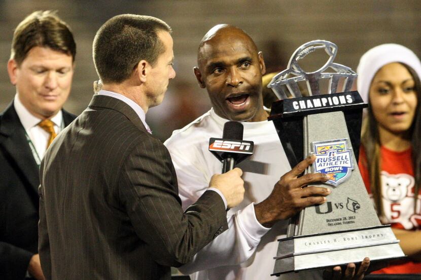 Former Louisville head coach Charlie Strong is presented with the Russell Athletic Bowl...