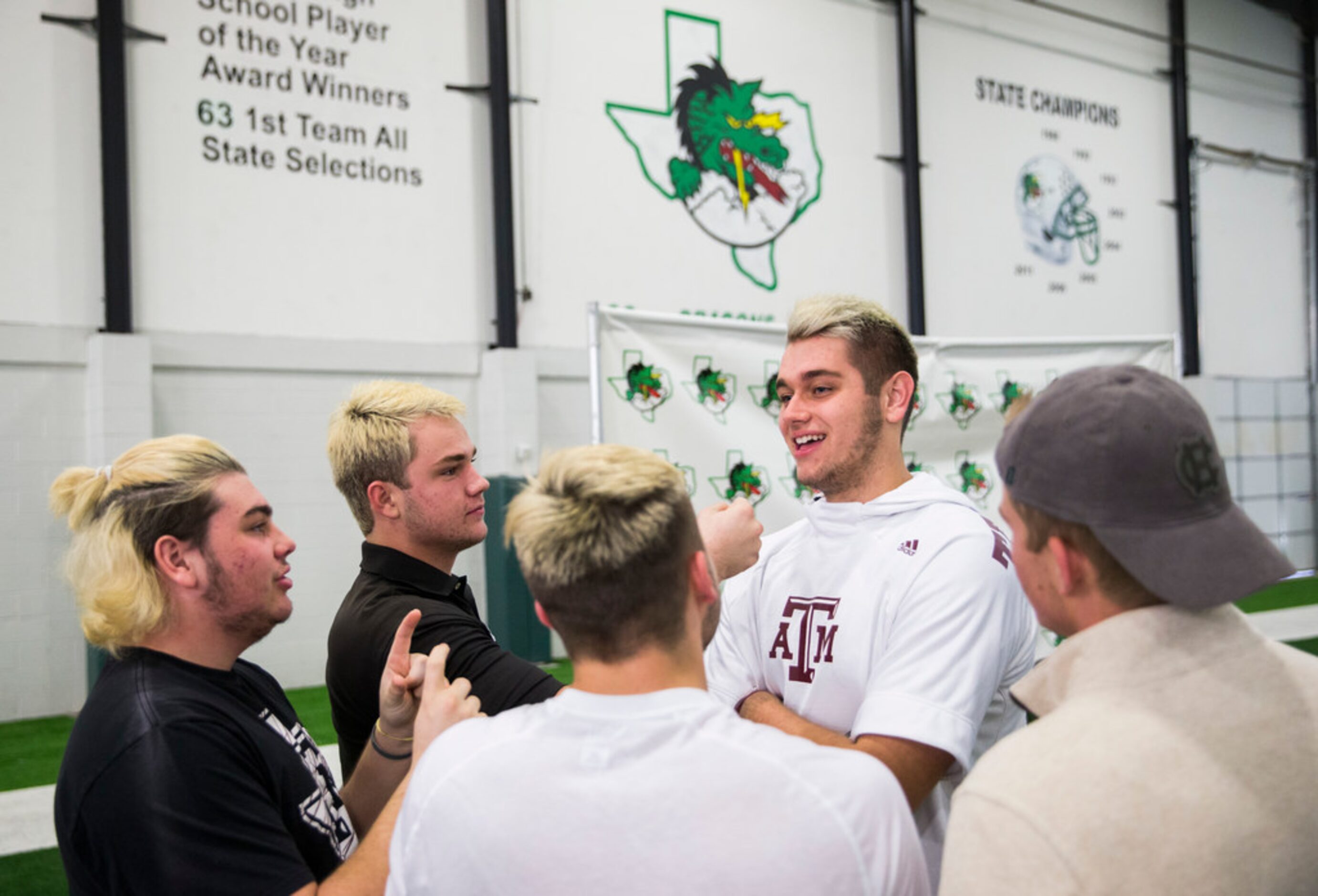 Southlake Carroll football players tease their team mate Blake Smith (second from right)...