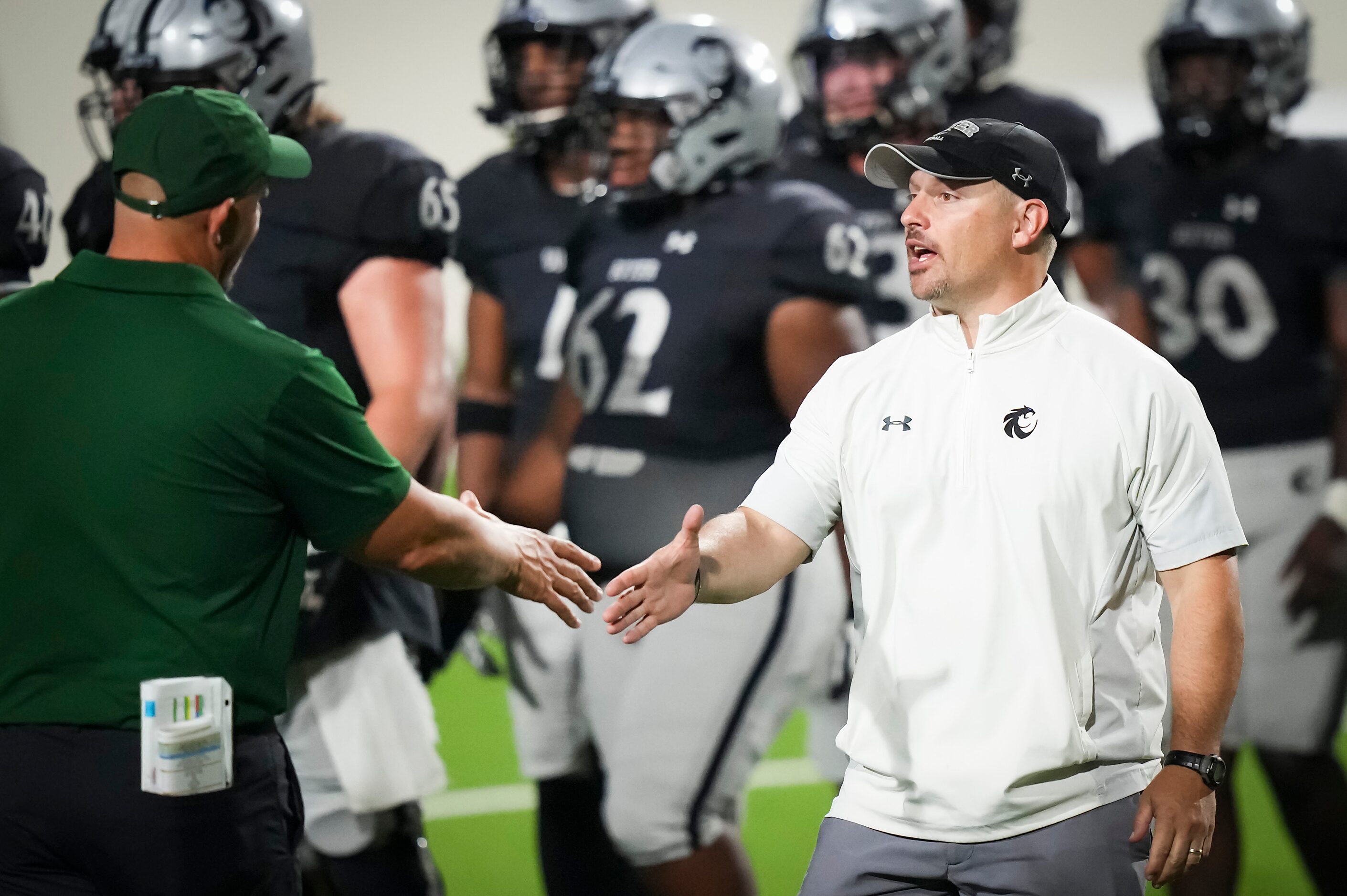 Denton Guyer head coach Reed Heim shakes hands with Prosper head coach Brandon Schmidt after...