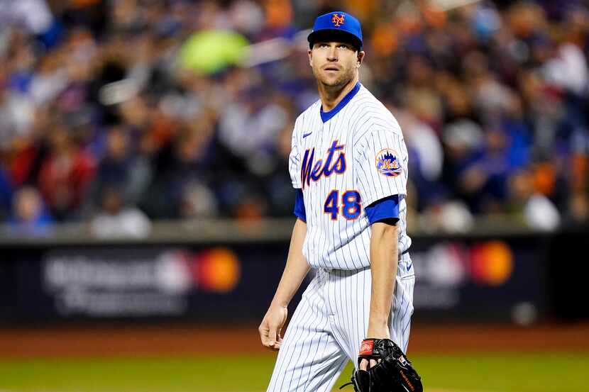 New York Mets starting pitcher Jacob deGrom (48) reacts after giving up a solo home run to...