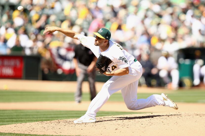 OAKLAND, CA - MARCH 29:  Kendall Graveman #49 of the Oakland Athletics pitches against the...