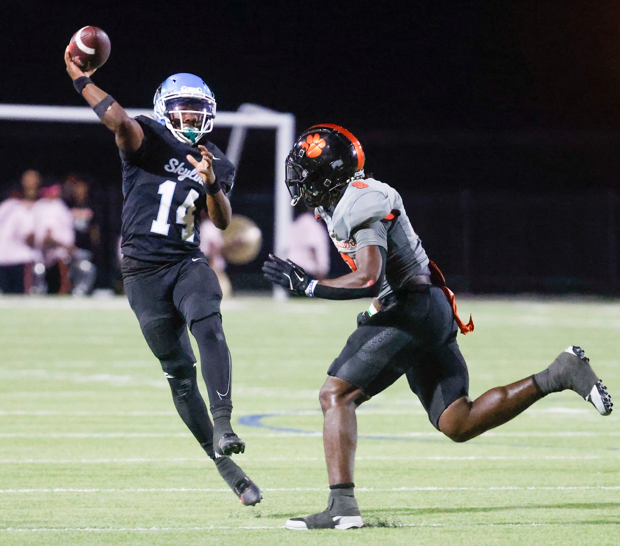 Skyline High’s QB Donta Ware (left) throws a pass past Lancaster High’s Dylan Sandles during...