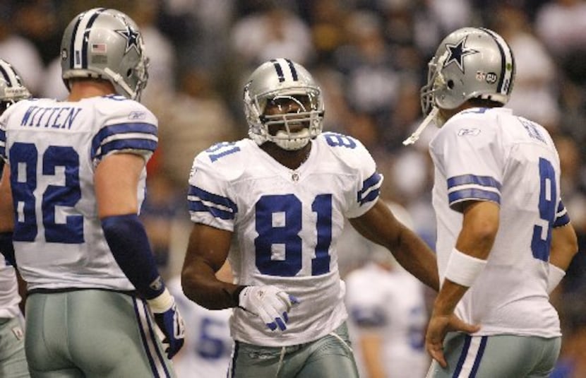 Dallas Cowboys wide receiver Terrell Owens, center, stands by tight end Jason Witten, left,...