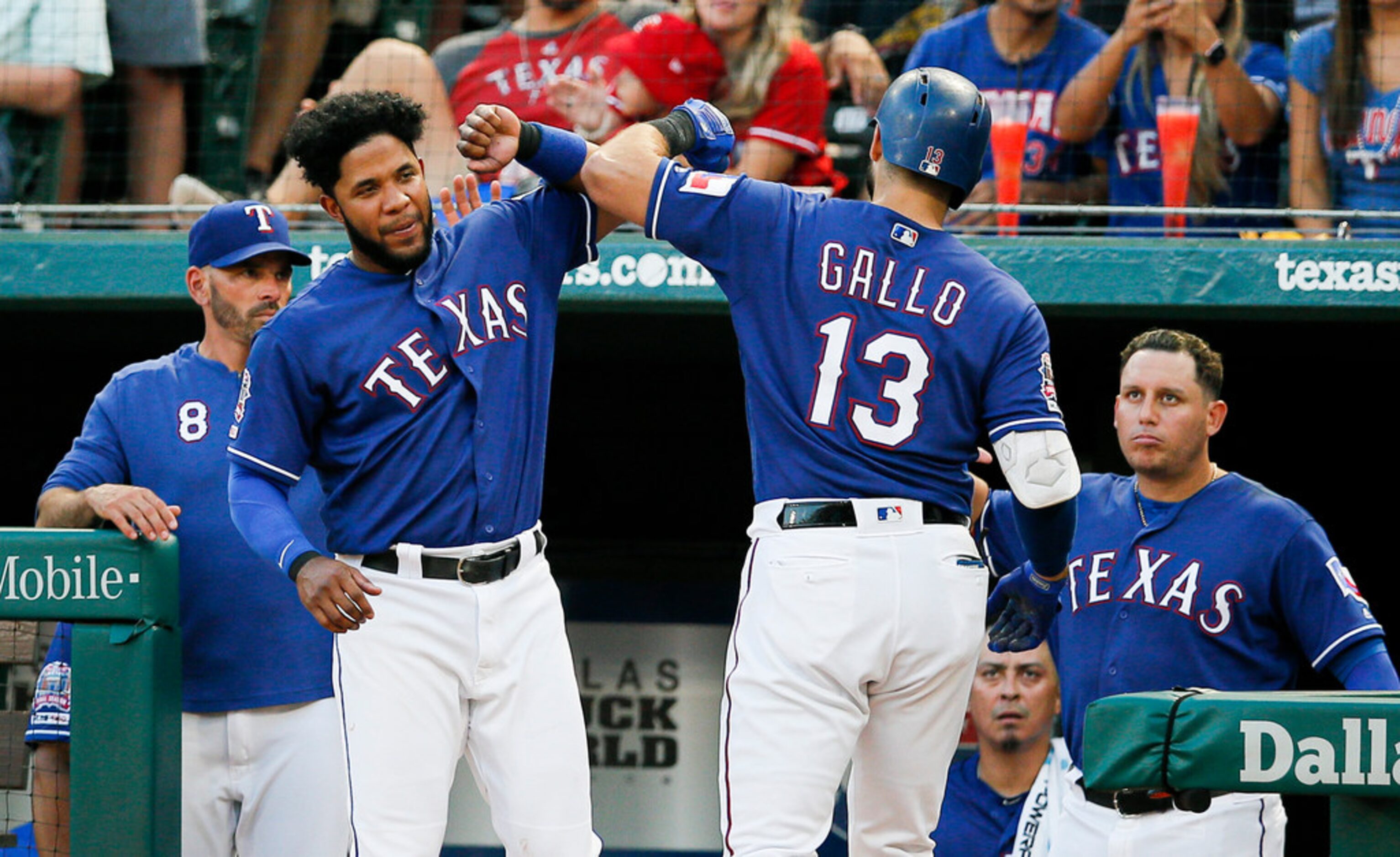 Texas Rangers' Joey Gallo (13) is congratulated by Elvis Andrus, left, after hitting a solo...