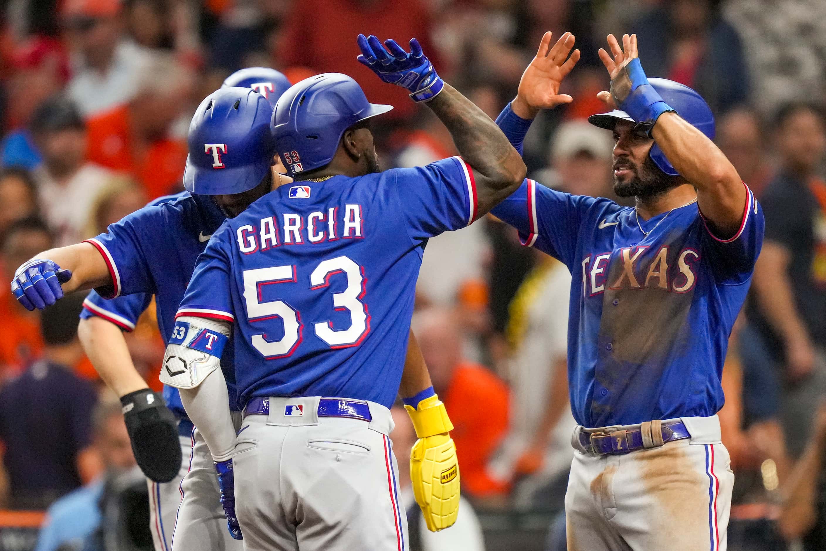 Texas Rangers right fielder Adolis Garcia (53) celebrates with second baseman Marcus Semien...