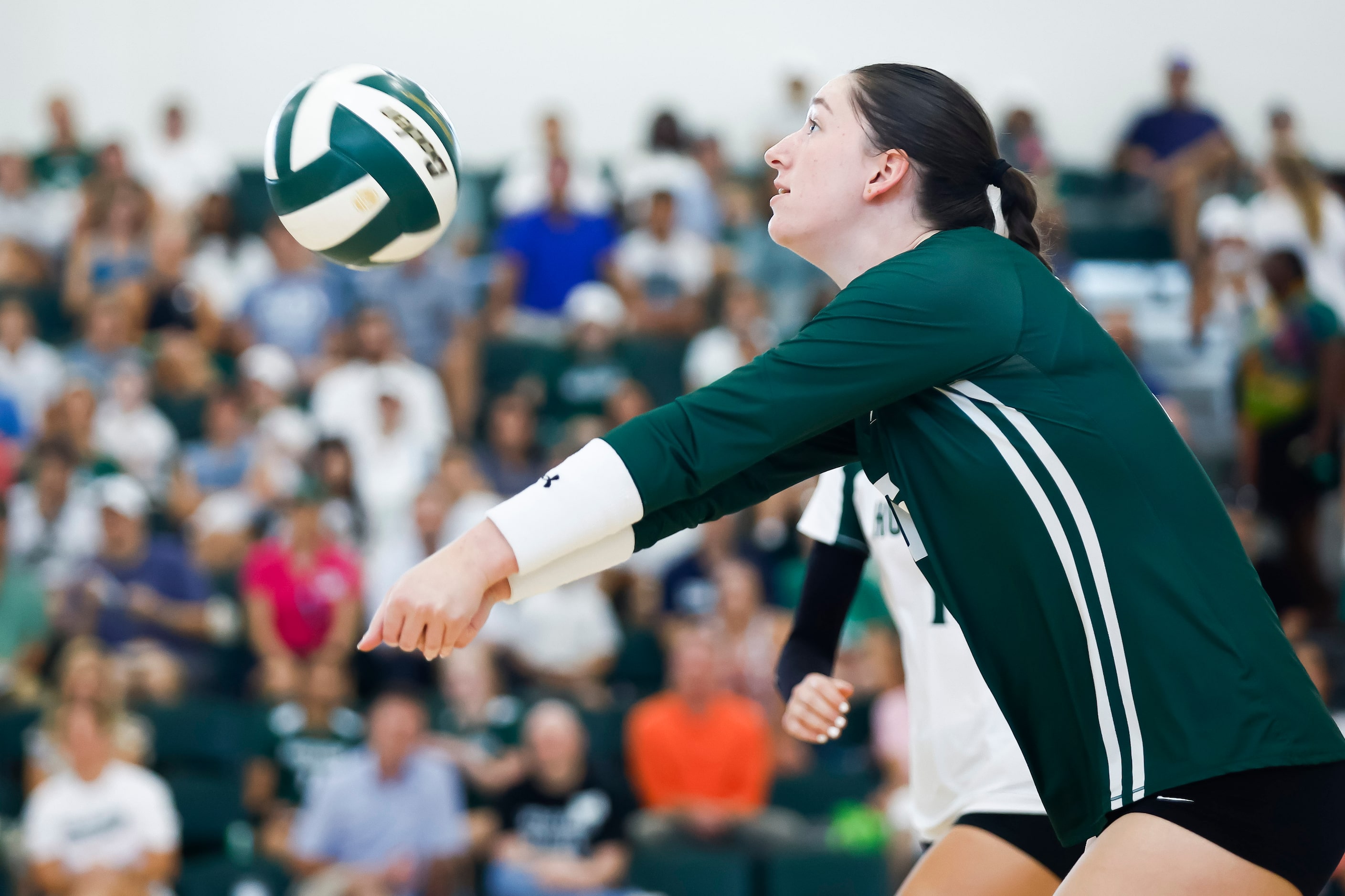 Hockaday junior middle blocker Olivia Wayne digs the ball during a high school volleyball...