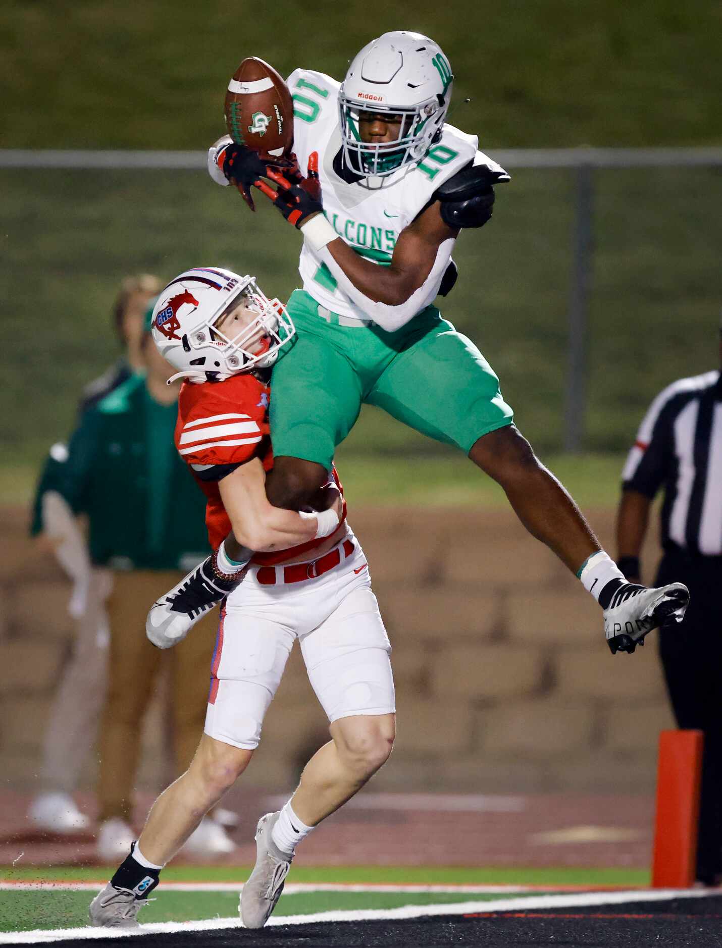 Lake Dallas receiver Keonde Henry (10) tries to corral a pass at the goal line as he’s hit...