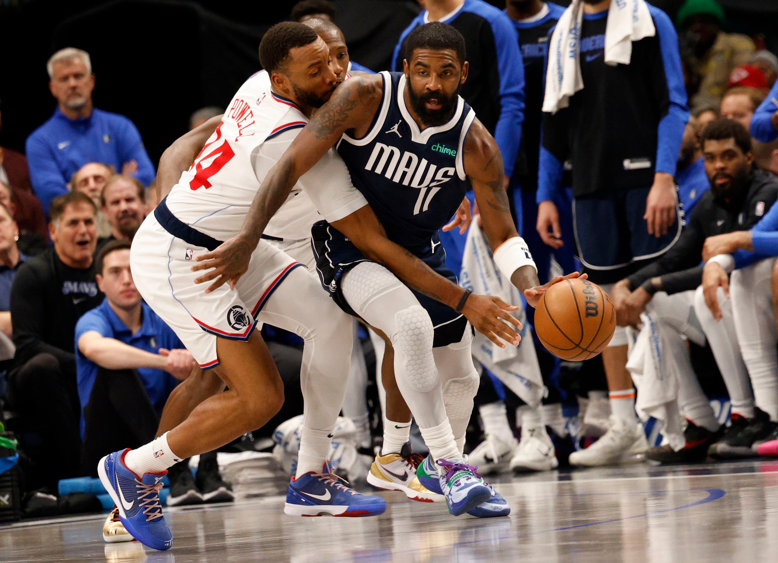 Dallas Mavericks guard Kyrie Irving (11) tries to drive past LA Clippers guard Norman Powell...