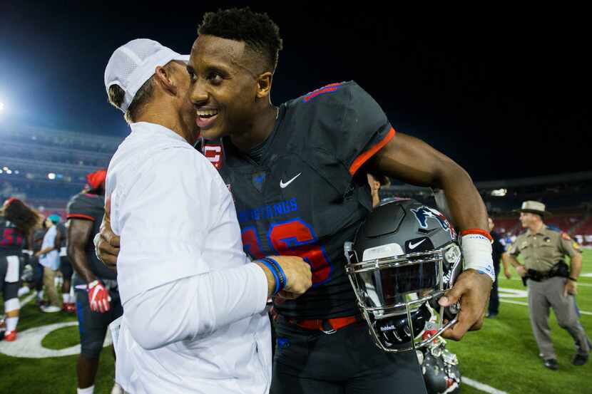 Southern Methodist Mustangs wide receiver Courtland Sutton (16) gets a hug from head coach...