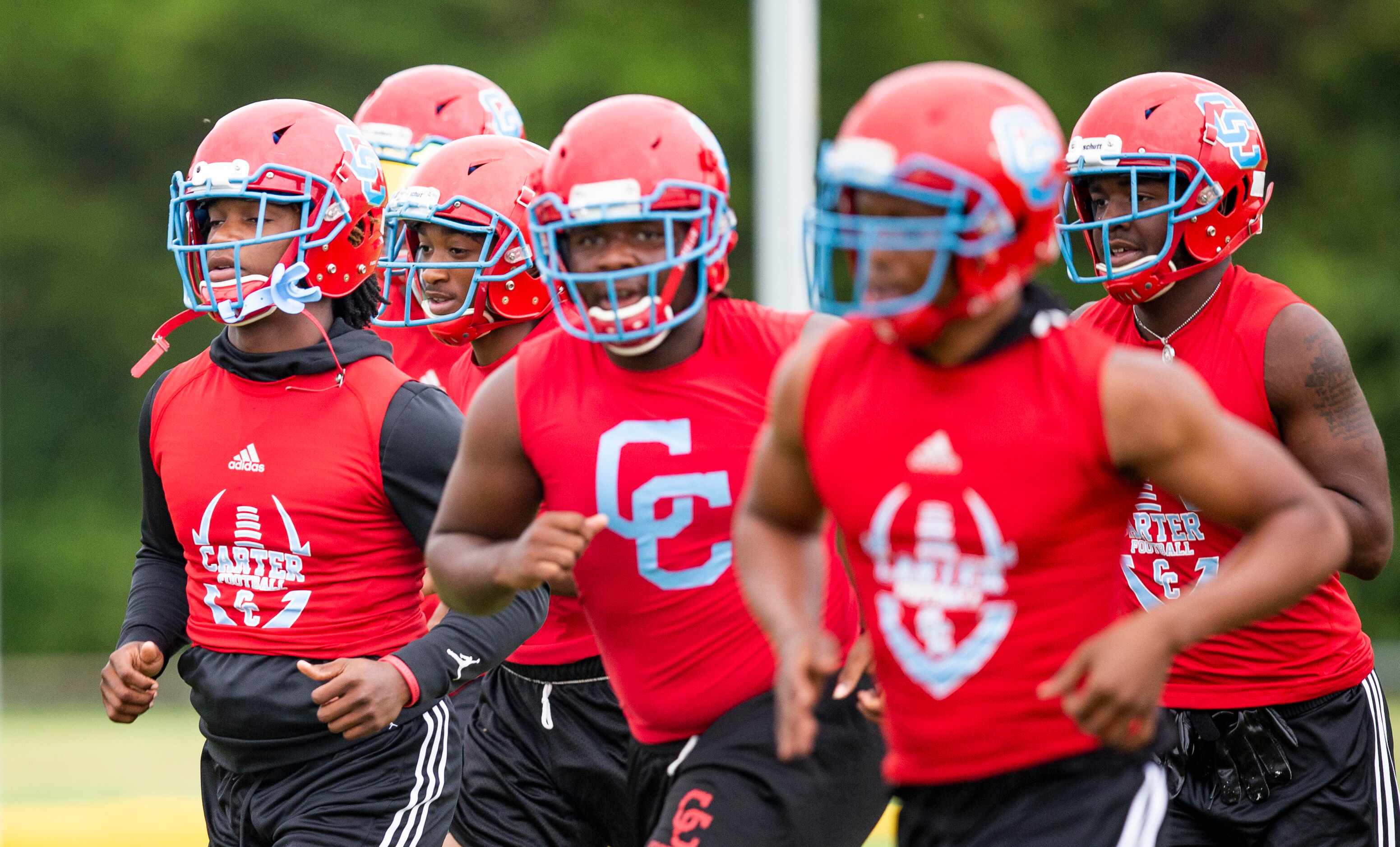 Carter senior linebacker Janari Hyder, left, and his teammates run drills during the first...