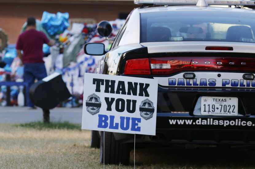 People paid their respects to the five Dallas police officers killed in the July 7 attack....
