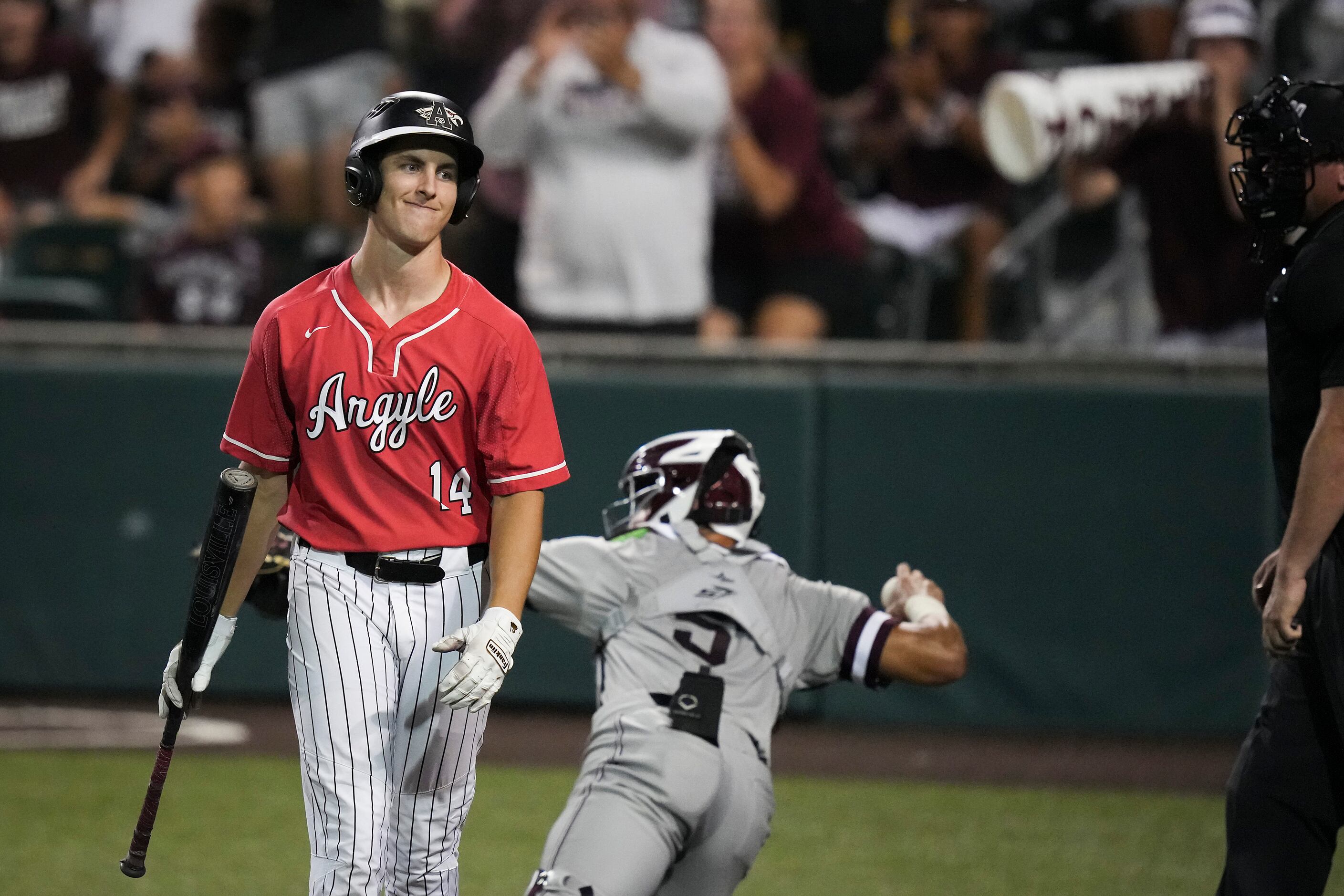 Argyle right fielder Ryan Hulke heads back to the dugout after striking out during the sixth...