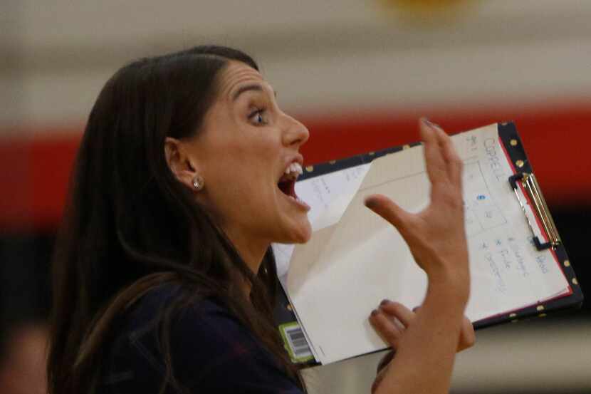 Lake Highlands head coach Abbey Perez delivers a message to her players from her spot on the...