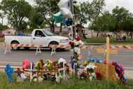 A memorial was set up for eight migrants who were killed while waiting at a bus stop in...