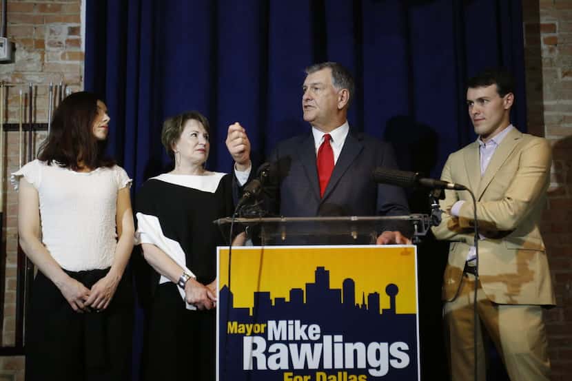 Mayor Mike Rawlings (center) is joined by his wife, Micki Rawlings, daughter Michelle and...