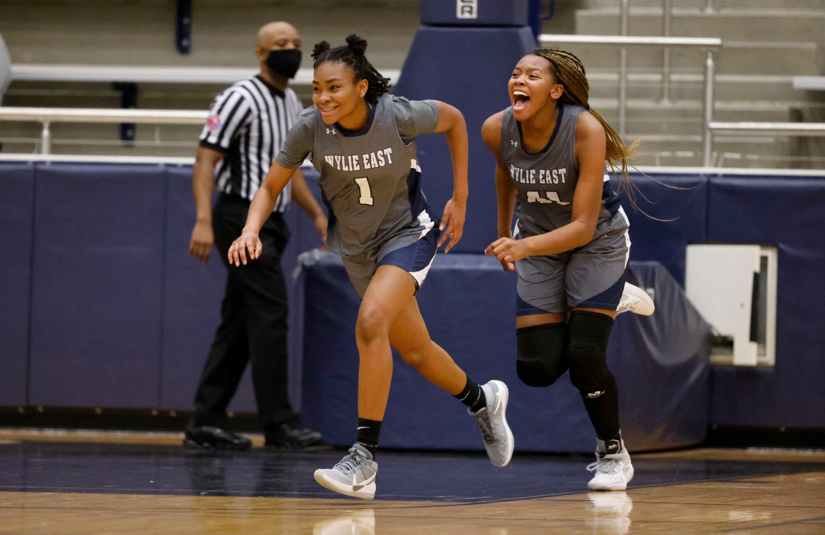 Wylie East’s  Taylor Dailey (1) and Akasha Davis (41) celebrate their overtime win (65-60)...