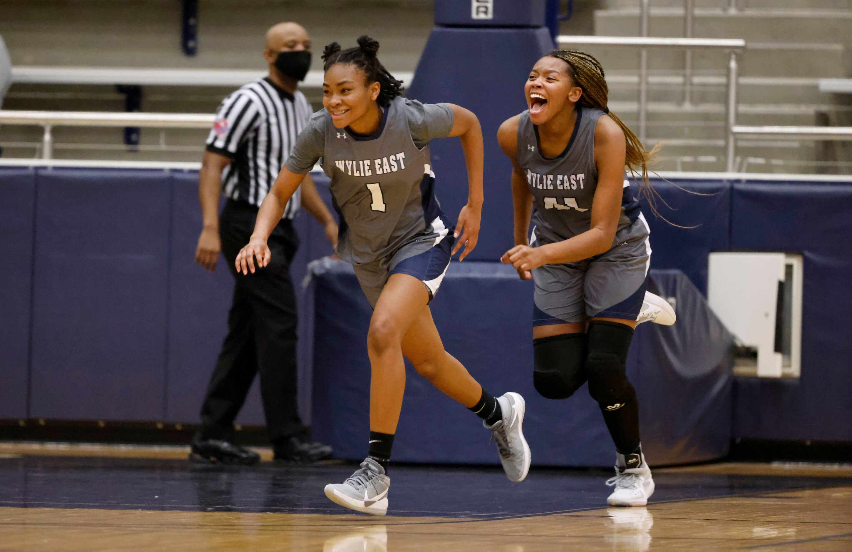 Wylie East’s  Taylor Dailey (1) and Akasha Davis (41) celebrate their overtime win (65-60)...