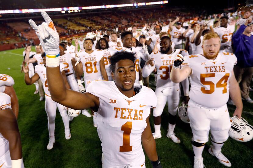 Texas wide receiver John Burt celebrates with teammates after an NCAA college football game...