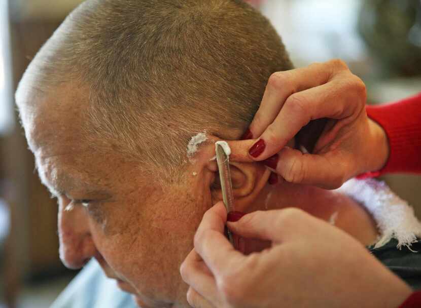 
Reagan Stripling, a five-year customer of Lakeland Barber Shop, gets his hair cut by owner...