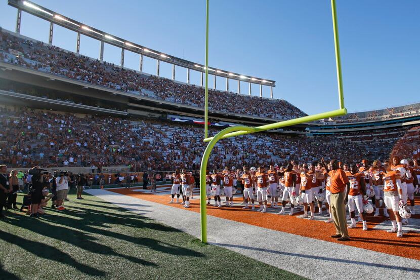 The Texas Longhorns stand in the end zone for the "Eyes of Texas" rendition before going to...