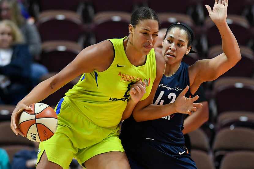 FILE - In this May 8, 2018, file photo, Dallas Wings' Liz Cambage, left, drives against...