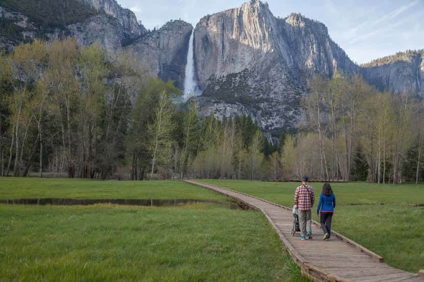 Hikers enjoy a spring stroll on a boardwalk in Yosemite Valley. 