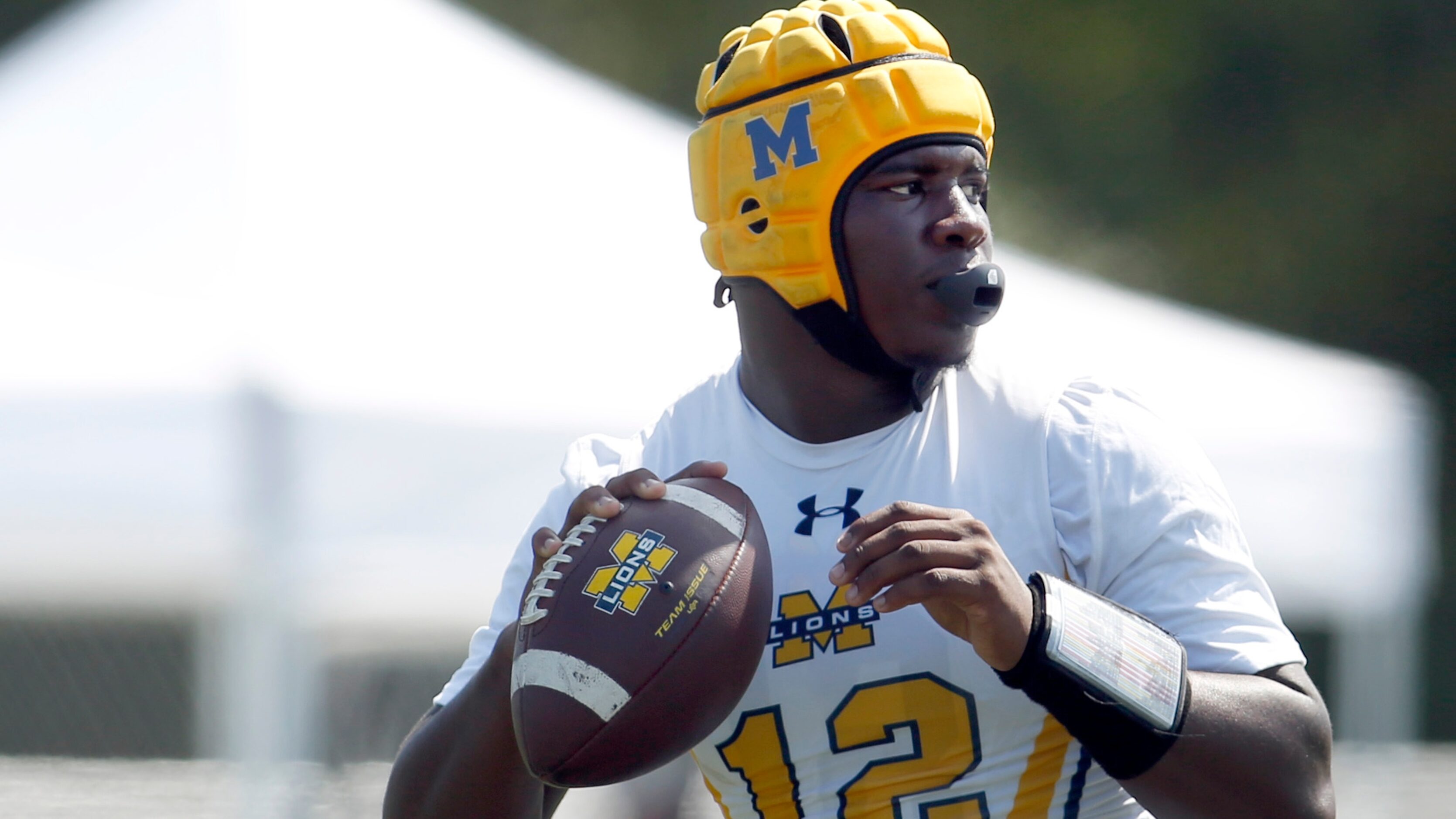 McKinney Lions quarterback Keldric Luster (7) prepares to launch a pass downfield in their...