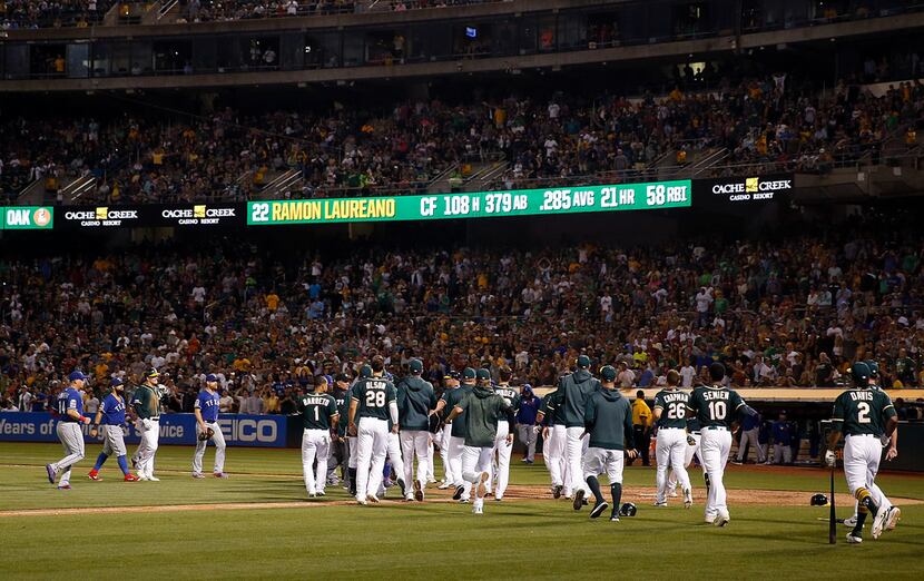 OAKLAND, CALIFORNIA - JULY 27: Texas Rangers and Oakland Athletics benches clear after Ramon...