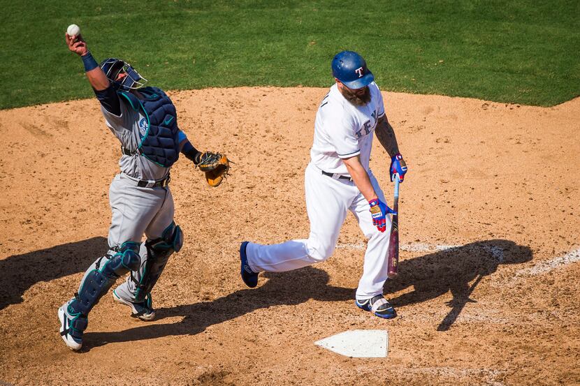 Seattle Mariners catcher Carlos Ruiz reaches for a ball fouled off by Texas Rangers pinch...