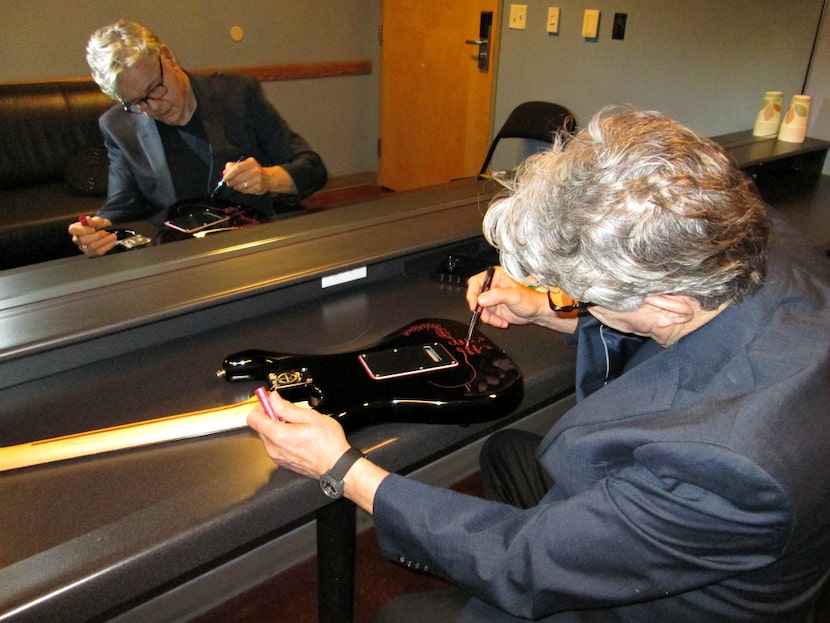  Steve Miller signing a guitar to be auctioned off for the Stevie Ray Vaughan-Jimmie Vaughan...